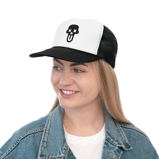 A person wearing a denim jacket and a black and white cap with a skull and crossbones design — bold graphic trucker hat for everyday wear.