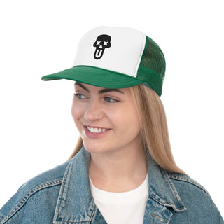 A woman wearing a green and white graphic trucker hat with a skull and UNFLTRD logo, paired with a blue denim jacket.