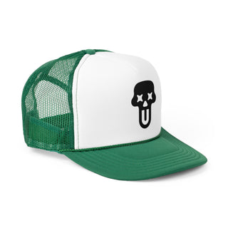 Green and white graphic trucker cap featuring a bold black skull and tongue graphic on the front panel.