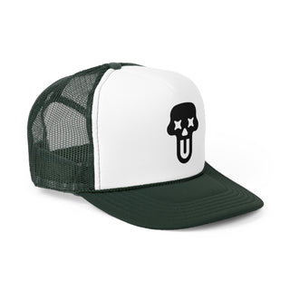 A stylish green and white trucker hat featuring a playful skull graphic with Xs for eyes and a tongue sticking out.