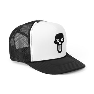 Black and white graphic trucker hat featuring a bold skull logo with crossed eyes on the front and a mesh back for ventilation.
