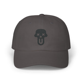 Dark gray dad cap featuring a prominent black skull logo with stars on either side. Simple and stylish headwear.