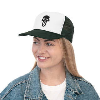 A person wearing a denim jacket and a white and black cap featuring a playful skull design, posing against a plain background.