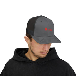 A person wearing a black hoodie and a gray baseball cap with a red UNFLTRD logo, styled with men's graphic streetwear.