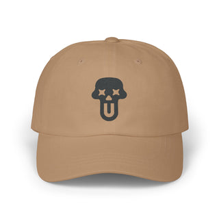 Brown graphic hat featuring a black skull design with stars for eyes and a sticking out tongue at the front.