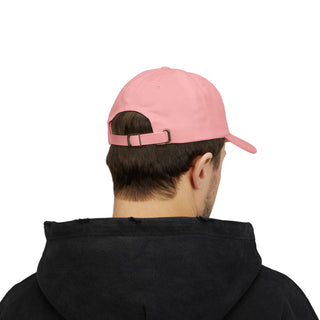A young man wearing a black graphic hoodie and a light pink baseball cap, viewed from behind, showcasing the cap's adjustable strap.