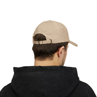A young man wearing a beige cap and black hoodie, viewed from behind, highlighting the cap's adjustable strap — casual men’s streetwear vibe.