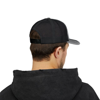 A man wearing a black cap and hoodie, viewed from the back, showcasing the cap mesh design and adjustable strap.