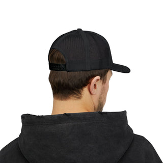 A young man wearing a black cap and men's graphic hoodie, viewed from behind, showcasing the cap's mesh back and casual style.